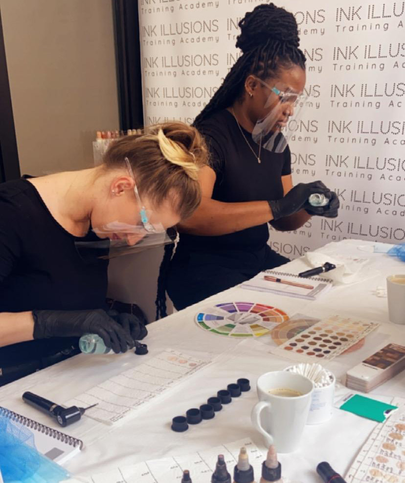 classroom photo of students learning colour theory for skin tone tattooing